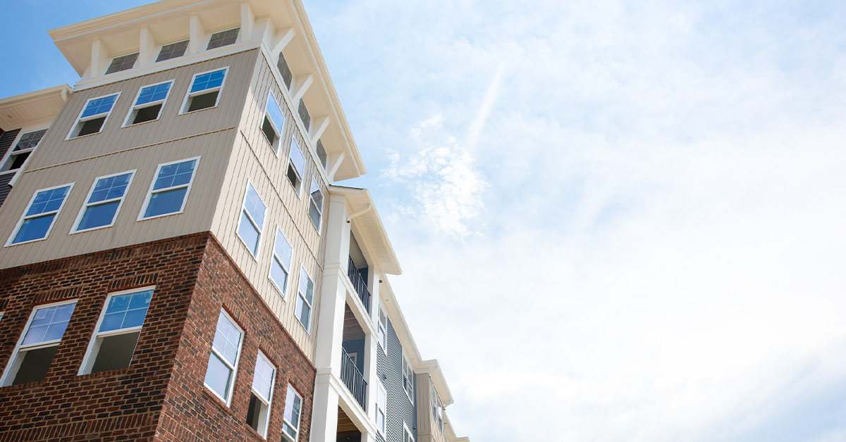 Image View of apartment building against a bright blue sky.