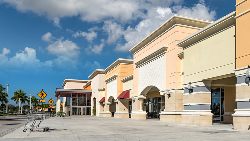 Image Strip mall with vacant storefronts.
