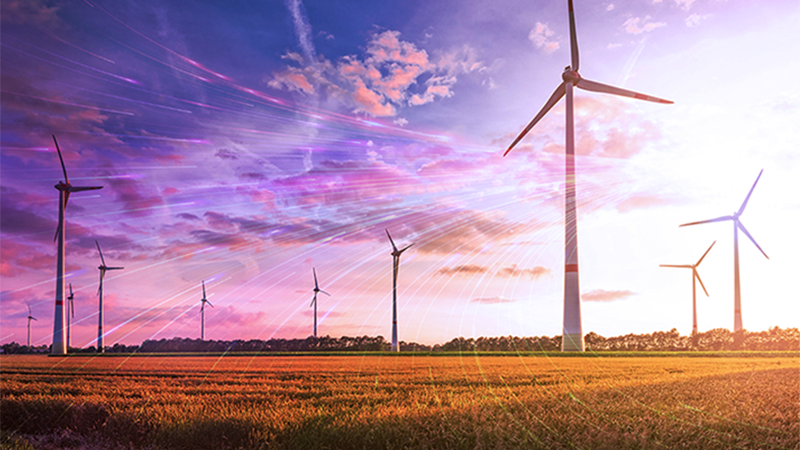 Image Wind farm: open field with  blue sky above features wind turbines being traversed by moving bright lines of light, representative of wind flow.