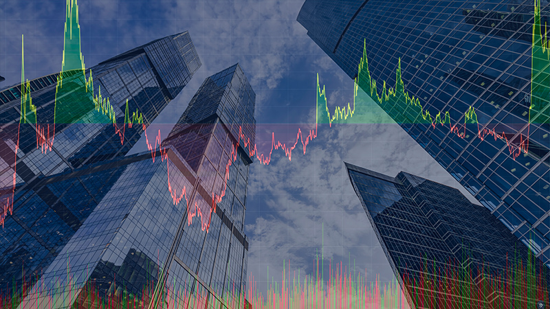 Image Commercial skyline of glass buildings, from ground perspective, with two superimposed line graphs.