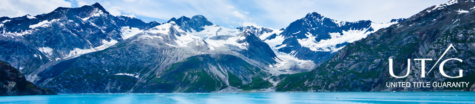 United Title Guaranty logo on image of airplane, lake and mountains