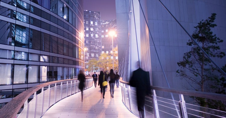 Pedestrian skybridge in a modern city at night