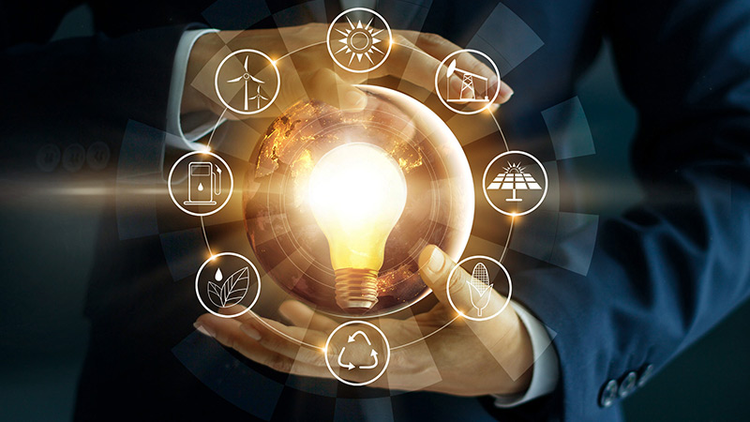 Hands capture light bulb surrounded with aura of diverse energy icons.