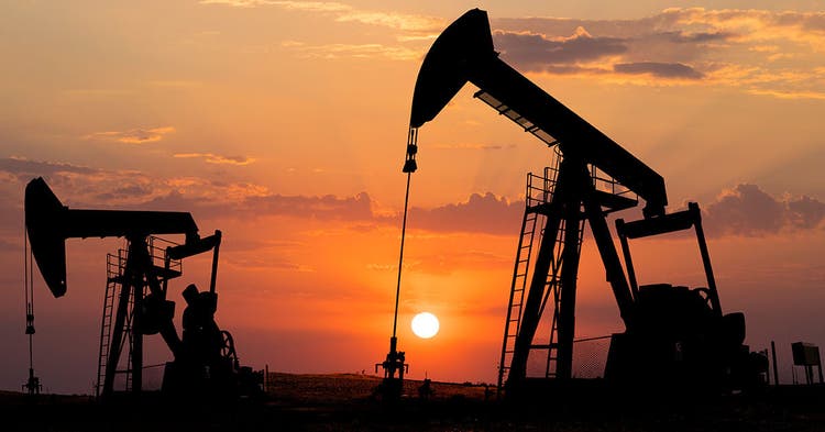 Field of oil pump jacks at sunset