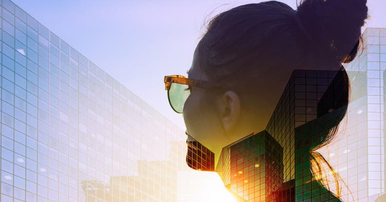 Female Wearing Sunglasses Looking Out of a High-rise Building