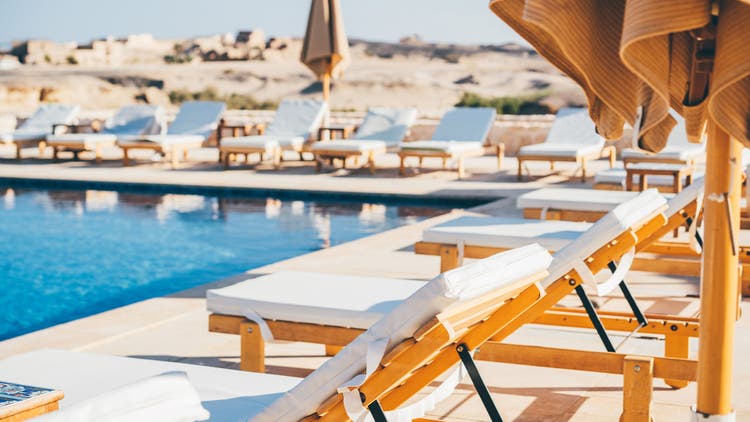 Lounge chairs beside pool.