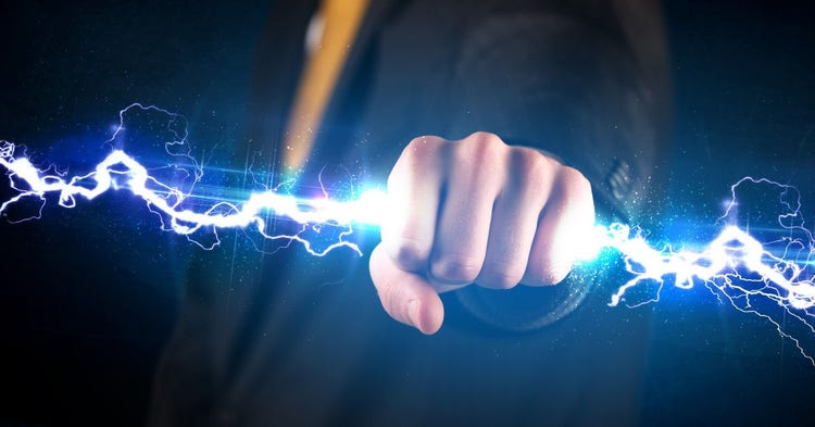 Businessman clutches a lightning bolt in his fist
