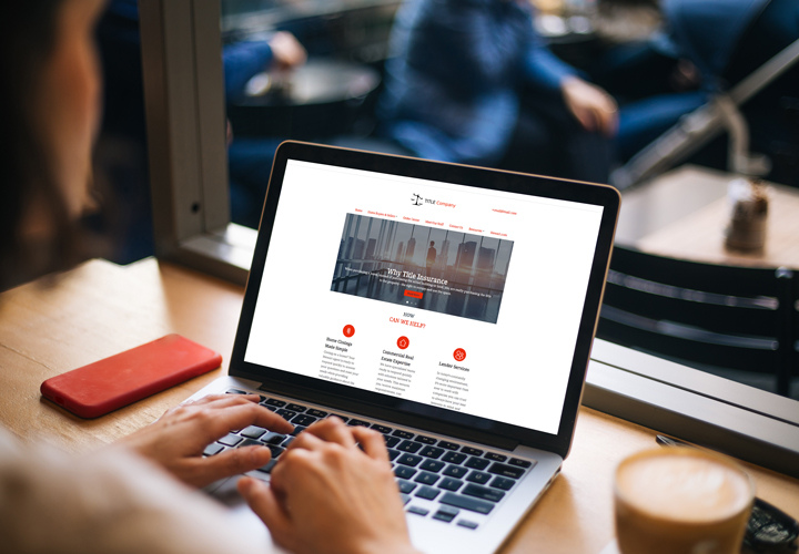 Title agent using StewartSitebuilder on her laptop.