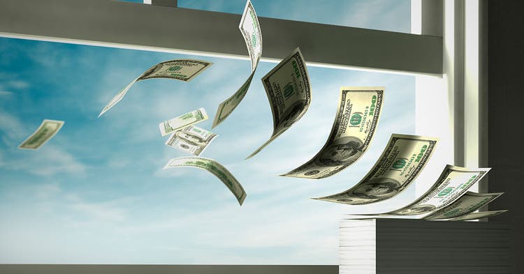 Stack of hundred dollar bills flutter out an open window