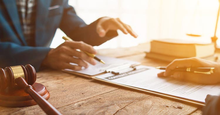 Documents are compared by two businessmen