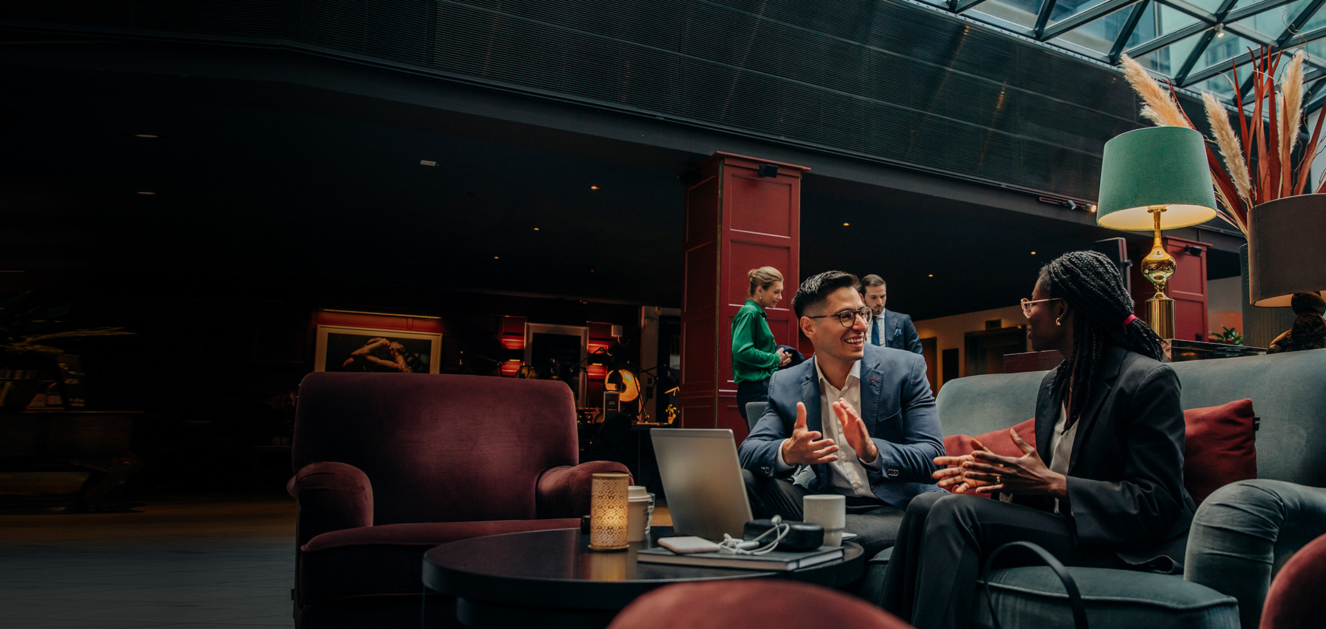 Two young business professionals meet in a hotel lobby